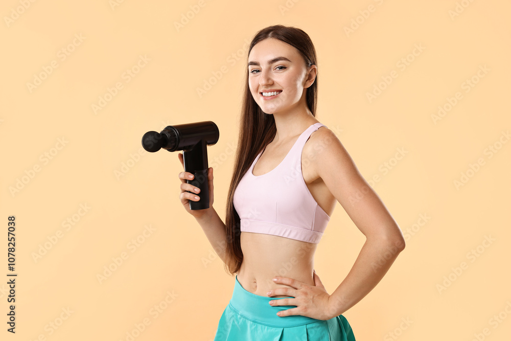 Young woman with percussive massager on beige background Young woman with percussive massager on beige background