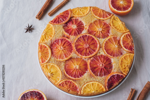 Delisious freshly baked homemade blood orange upside-down cake on neutral background. Popular winter holiday dessert.