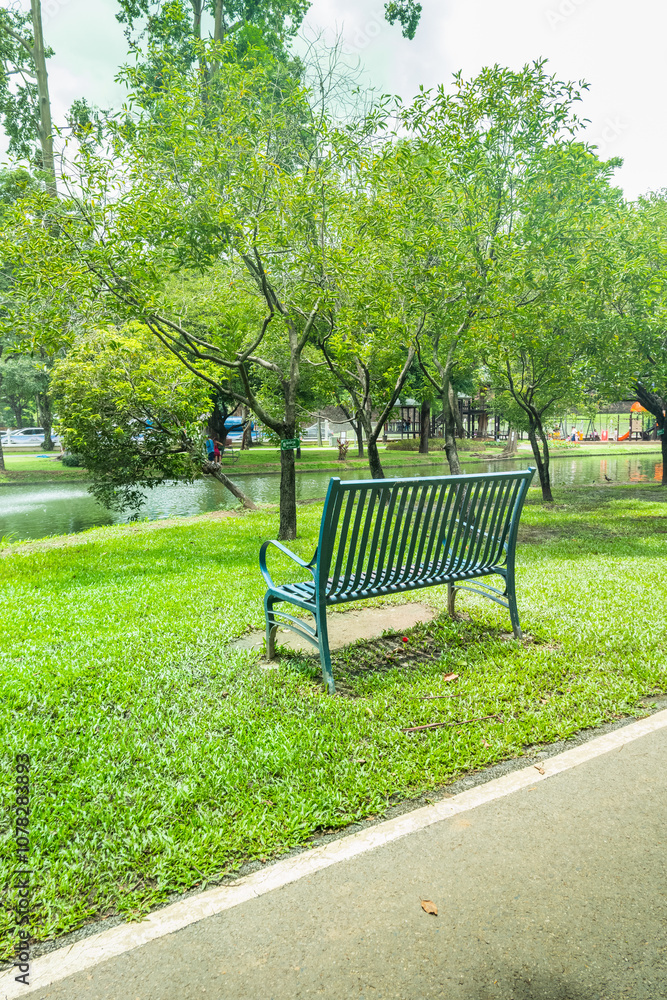 Modern bench in a public Park with view of fountain in the water pond public park,lake during spring,Beautiful green garden and Big tree,reflection in the lake in the morning,Resting in Park.. Modern bench in a public Park with view of fountain in the water pond public park,lake during spring,Beautiful green garden and Big tree,reflection in the lake in the morning,Resting in Park..