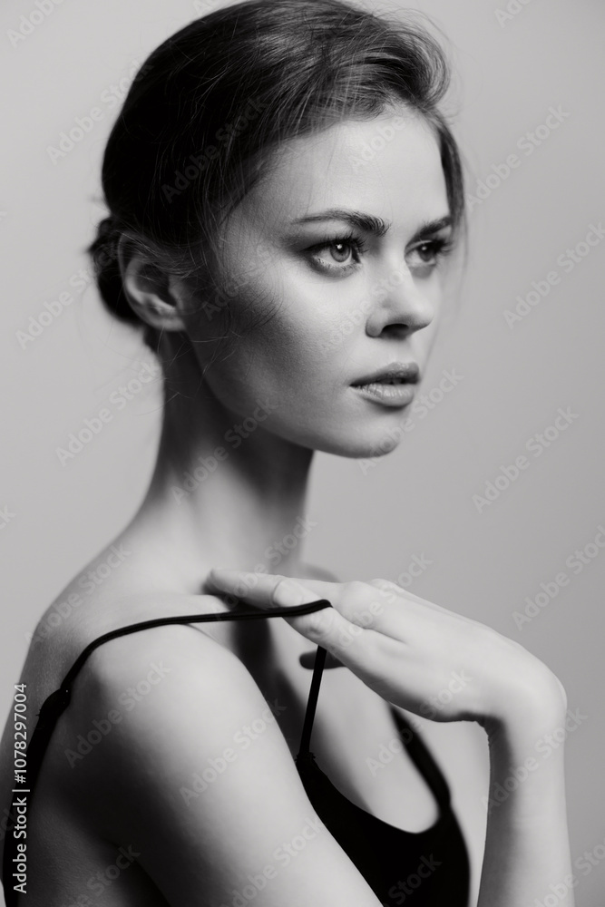 © SHOTPRIME STUDIO - Elegant young woman with a serene expression, posing in a studio setting with soft lighting and a monochrome background. Fashion and beauty concept.