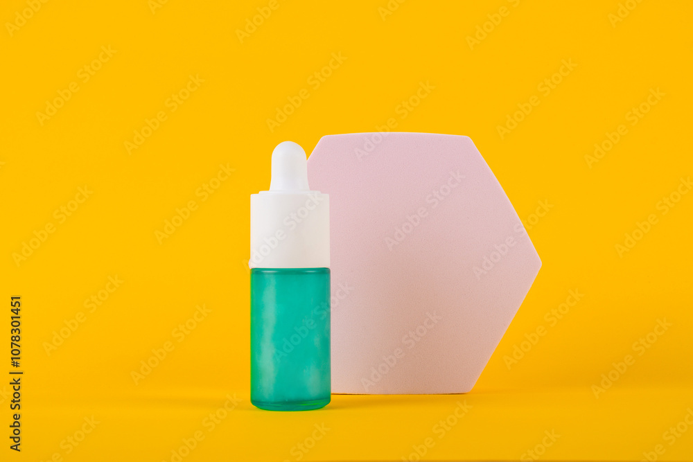 Blue glass cosmetic bottle, Skin care or sunscreen cosmetic with stylish props on yellow background. Blue glass cosmetic bottle, Skin care or sunscreen cosmetic with stylish props on yellow background.