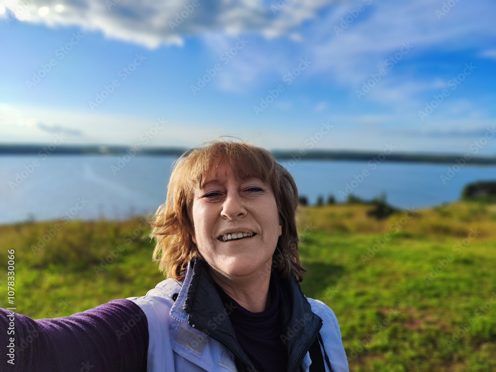 Blogger enjoying a scenic view by the lake during a sunny afternoon in a tranquil destination Blogger enjoying a scenic view by the lake during a sunny afternoon in a tranquil destination