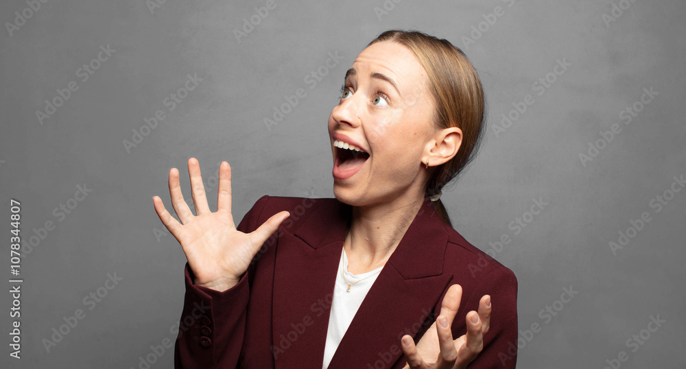 Fototapeta premium feeling happy, amazed, lucky and surprised, celebrating victory with both hands up in the air