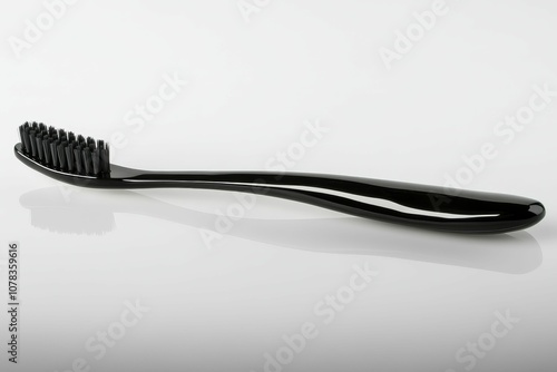 Black toothbrush on white background.