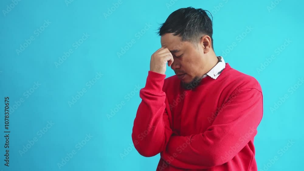 Stressed Asian Man Holding Nose And Shaking His Head Showing Disappointed Expression Stressed Asian Man Holding Nose And Shaking His Head Showing Disappointed Expression