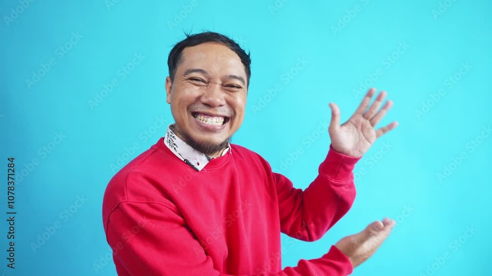 Amazed Young Casual Man Presenting Something On Blue Background Amazed Young Casual Man Presenting Something On Blue Background