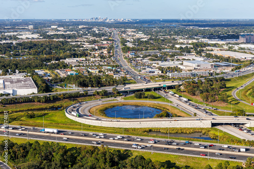 Obraz na płótnie Aerial view on interstate crossing with Floridas Turnpike and Martin Andersen Beachline Expy with downtown in the background in Orlando, United States w salonie