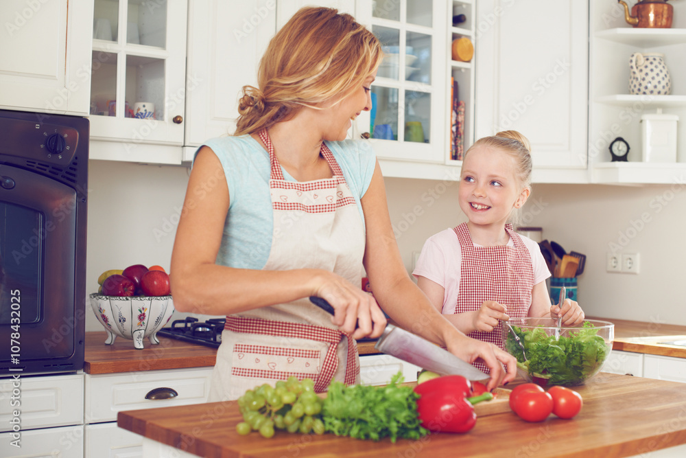 Mother, kid and vegetables for salad in kitchen with cutting ingredients, meal prep and teaching healthy vegan recipe. Woman, girl and learning to cook with support, helping hand and bonding in home Mother, kid and vegetables for salad in kitchen with cutting ingredients, meal prep and teaching healthy vegan recipe. Woman, girl and learning to cook with support, helping hand and bonding in home
