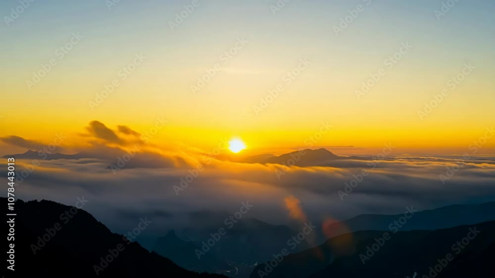 Timelapse of the sun rising over a mountain range with clouds. Timelapse of the sun rising over a mountain range with clouds.