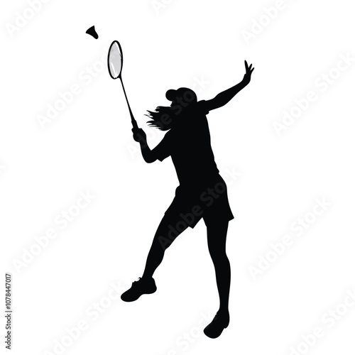 A woman is playing badminton and holding a racket. She is in the air and has a racket in her hand