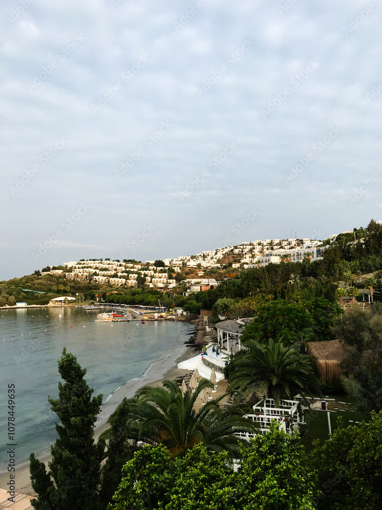 Coastal resort landscape with lush greenery and white buildings. Bodrum, Turkey. Coastal resort landscape with lush greenery and white buildings. Bodrum, Turkey.