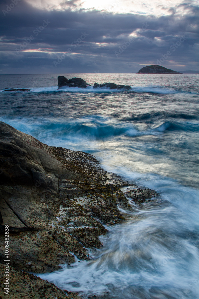 Long exposure of water crashing over coastal rocks. Long exposure of water crashing over coastal rocks.