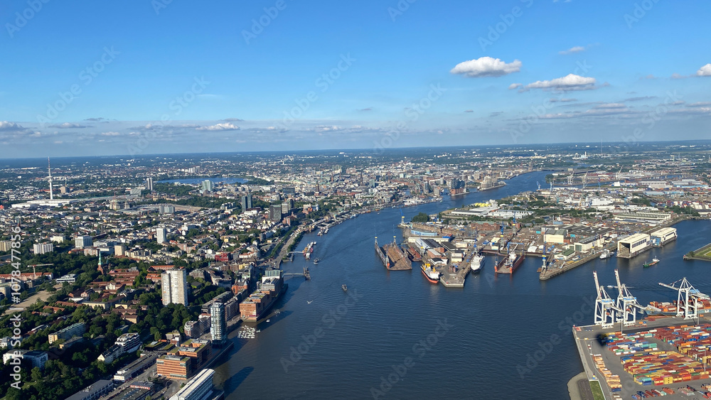 Naklejka premium Aerial View of Cityscape with River and Shipping Port