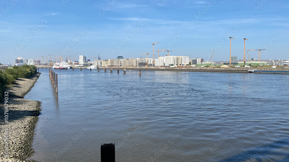Fototapeta premium Urban Riverfront with Construction and Cruise Ship in View
