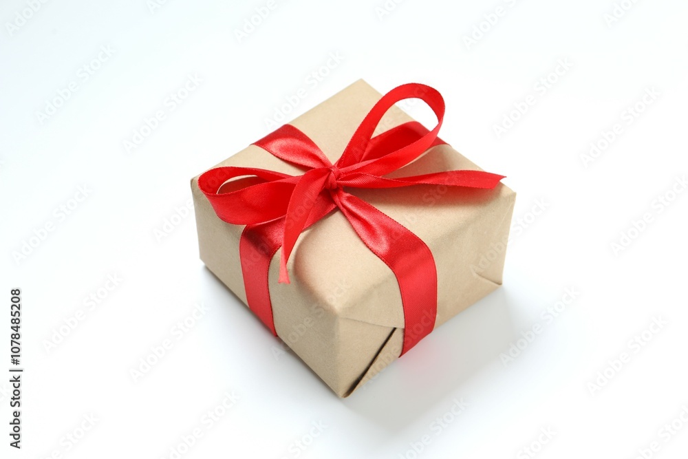 Obraz premium Beautiful gift box tied with golden bow on color background 
