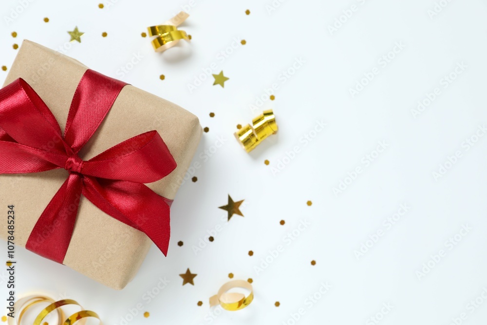Beautiful gift box tied with golden bow on color background Beautiful gift box tied with golden bow on color background