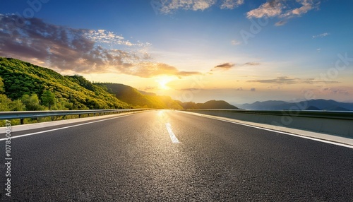 asphalt highway road and green mountain with sky clouds at sunset