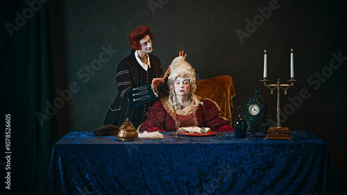 Φωτογραφία Loyal court favorite brushes wig of elegantly dressed empress, elderly woman in period attire, with serious face, sitting at table with serious face