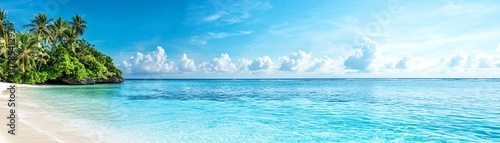 Tranquil beach view with clear water and blue skies, ideal for relaxation and escape.