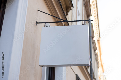 Obraz na płótnie Street storefront shop, cafe, restaurant mounted signboard mock up design template. Blank white store sign design mockup. w salonie