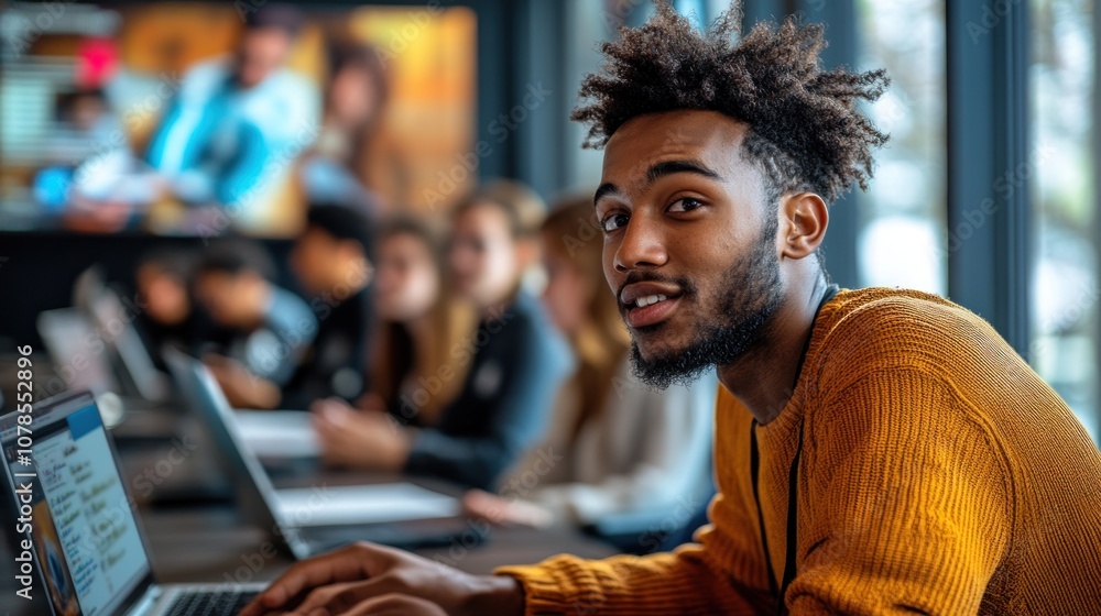 Young man working on a laptop in a modern office Young man working on a laptop in a modern office