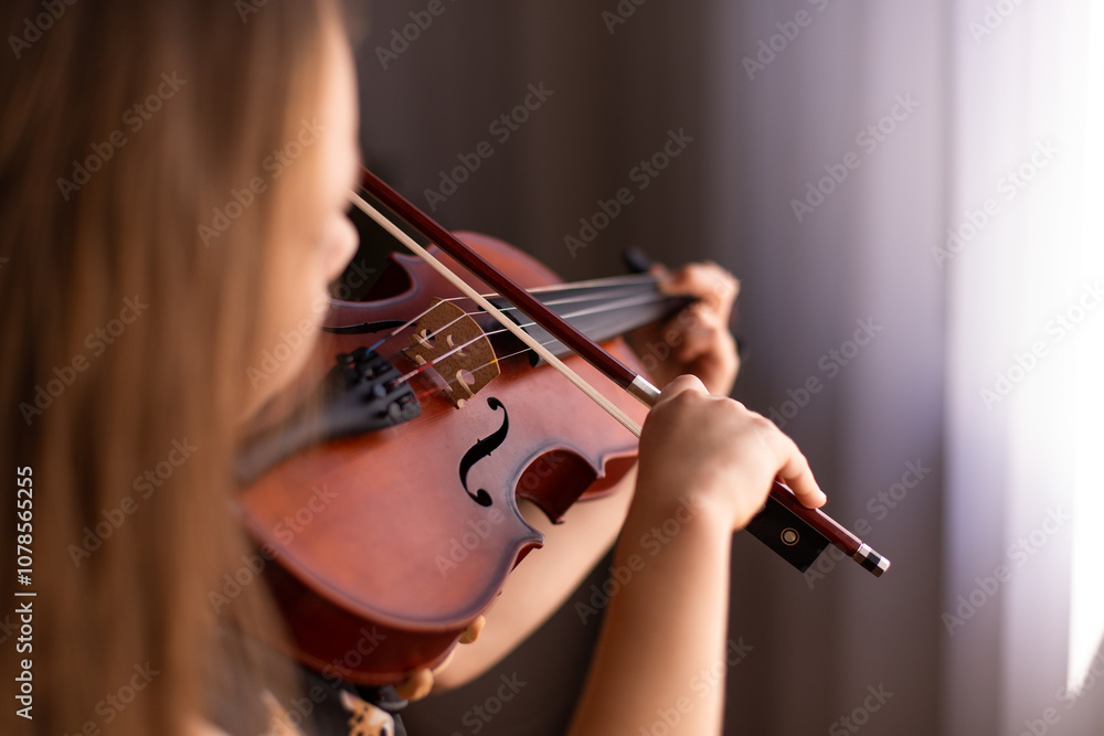 child playing notes on a violin deep in concentration child playing notes on a violin deep in concentration