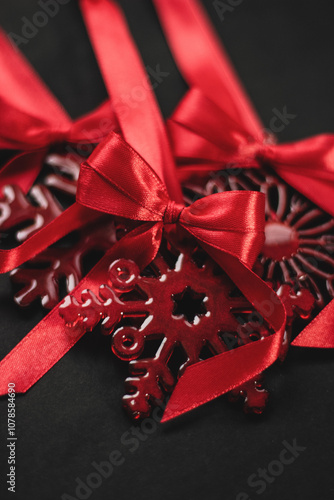 Elegant red snowflake tree ornament with satin bow, festive Christmas decoration symbolizing holiday cheer in vibrant red hue