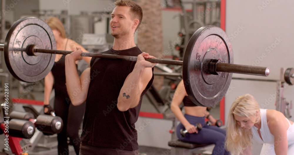 He lifts the barbell, she lifts the kettlebell. Sport enthusiasts actively engage in a wide variety of exercises within a vibrant and dynamic gym setting He lifts the barbell, she lifts the kettlebell. Sport enthusiasts actively engage in a wide variety of exercises within a vibrant and dynamic gym setting