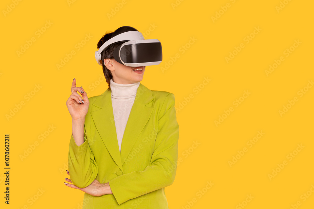 Woman enjoying virtual reality experience while smiling against a bright yellow background Woman enjoying virtual reality experience while smiling against a bright yellow background