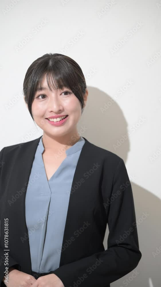 Fresh young sincere looking woman with business image with laptop looking up in suit Vertical video on white background Fresh young sincere looking woman with business image with laptop looking up in suit Vertical video on white background