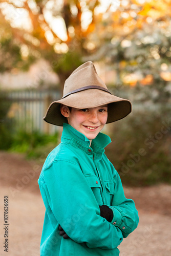 Portrait of young Australian boy in backyard with akubra hat on photo