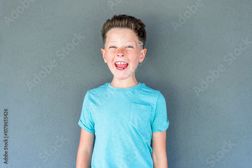 Playful expression of a mischievous boy with cheeky smile photo