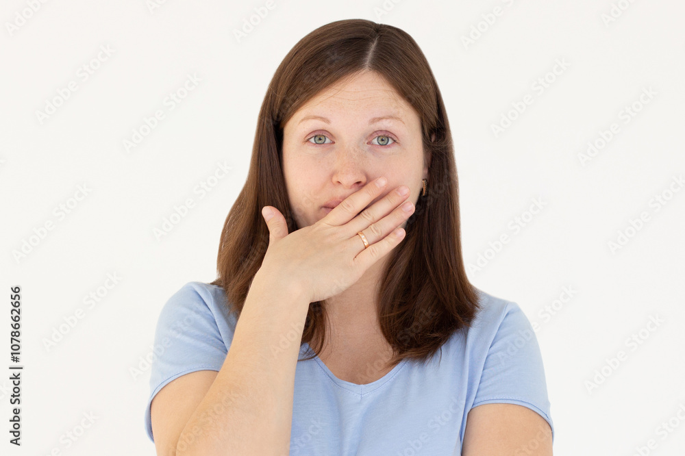 Happy woman closing her mouth with hand going to see surprise prepared by husband standing and smiling in anticipation for something wonderful. Young lady covering mouth with hands Happy woman closing her mouth with hand going to see surprise prepared by husband standing and smiling in anticipation for something wonderful. Young lady covering mouth with hands