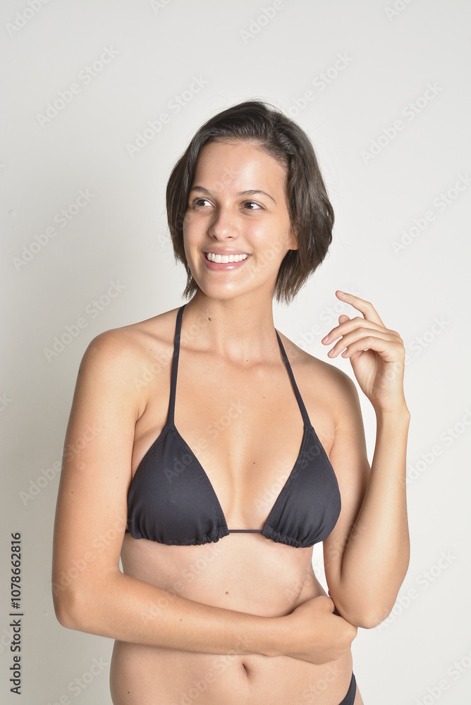 Obraz premium short hair, natural, no makeup, woman, white t-shirt, black pants, blue swimsuit, bikini, skates, casual, authentic, lifestyle, candid, minimal, female model, simplicity, everyday look, relaxed, comfo