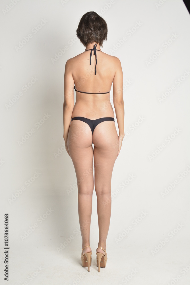 Fototapeta premium short hair, natural, no makeup, woman, white t-shirt, black pants, blue swimsuit, bikini, skates, casual, authentic, lifestyle, candid, minimal, female model, simplicity, everyday look, relaxed, comfo