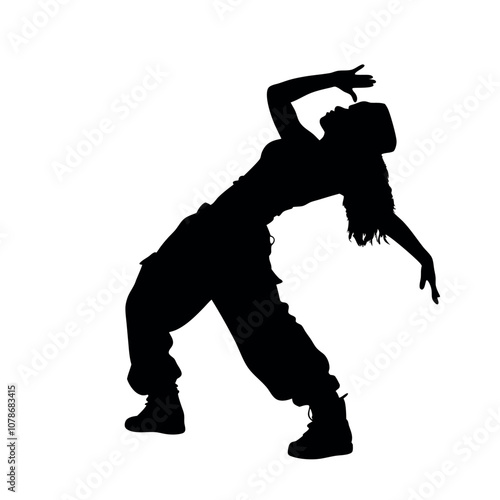A woman is dancing in a black and white picture. She is wearing a hat and has her hands on her hips