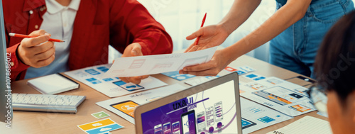 Panorama banner of startup UX developer or company employee design user interface or UI prototype for mobile application or website software with software display on laptop monitor in office. Synergic photo