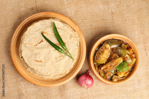 Jowar Roti or Jowar Bhakri with brinjal curry ,  a staple food in the Indian states of Maharashtra, Gujarat, and Karnataka. Sorghum is a versatile and nutrient-rich grain. photo