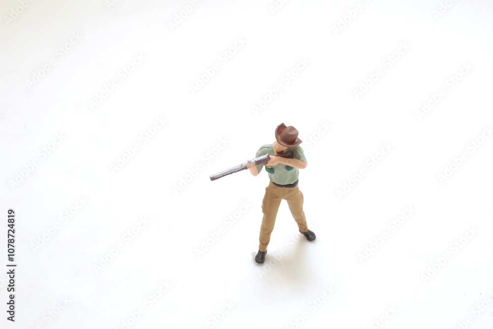 Plastic Cowboy Figure Holding a Rifle on White Background Plastic Cowboy Figure Holding a Rifle on White Background