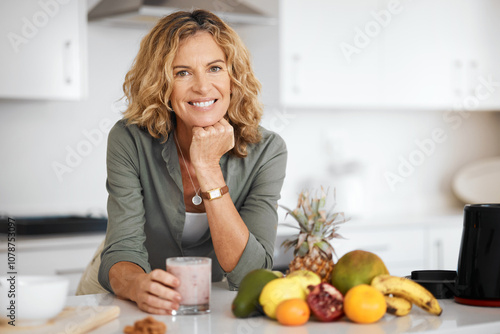 Photos Mature woman, smoothie and portrait in kitchen with smile for nutrition, wellness and meal prep in home