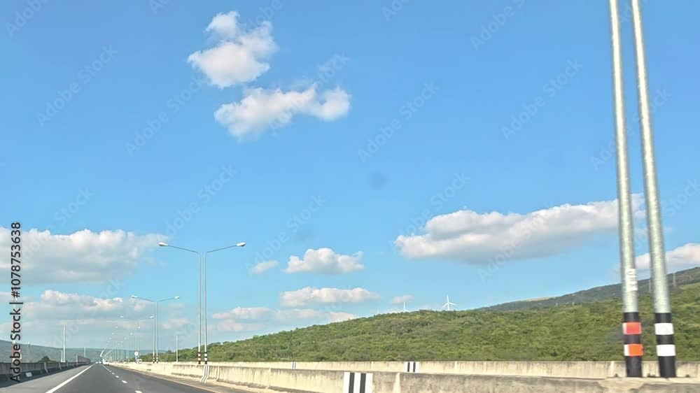 Endless Road Ahead: A picturesque highway stretches towards a distant horizon, with a clear blue sky and fluffy clouds above. Endless Road Ahead: A picturesque highway stretches towards a distant horizon, with a clear blue sky and fluffy clouds above.