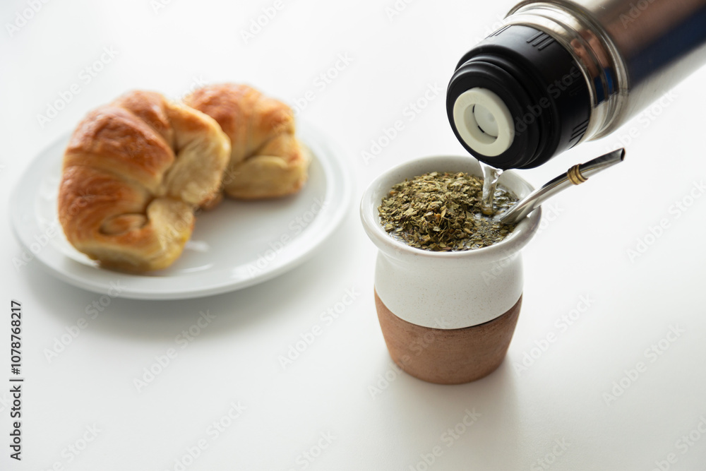 A popular breakfast in Argentina: Yerba mate, a type of strong green tea, and argentinian croissants called medialunas