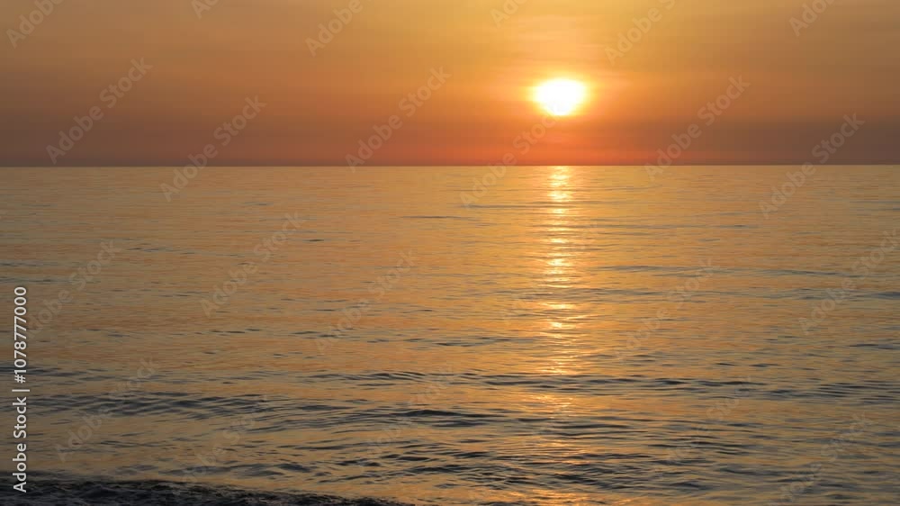 Beautiful wave in orange sunset on the sea Beautiful wave in orange sunset on the sea