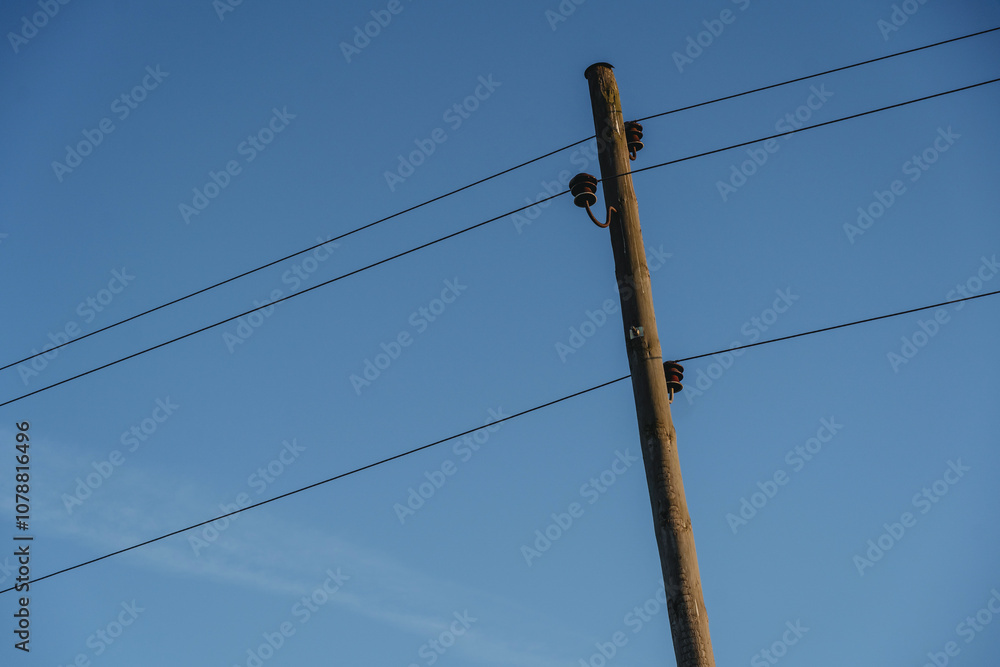 Utility Pole with Power Lines Against Clear Blue Sky Utility Pole with Power Lines Against Clear Blue Sky