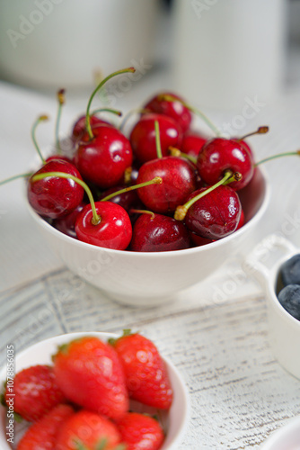 morning breakfast, juicy berries in a light plate, cherries, strawberries, raspberries