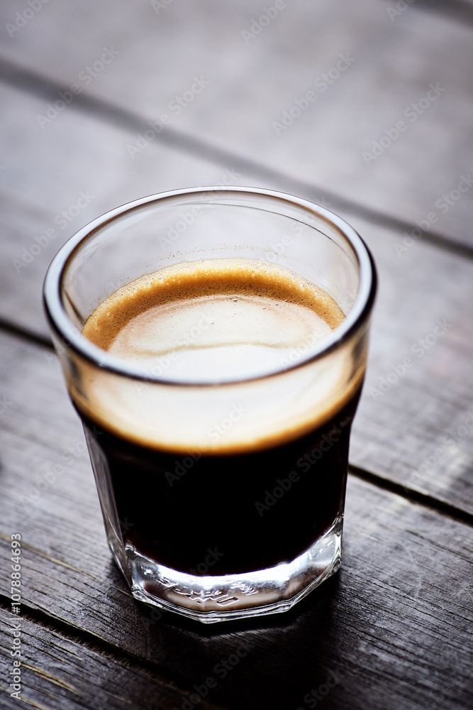Coffee in glass cup on dark background. Close up. Copy space. Coffee in glass cup on dark background. Close up. Copy space.