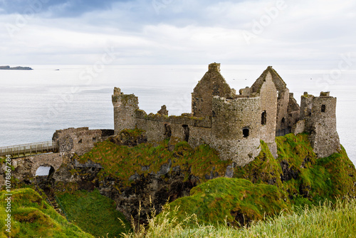 Ruins of Dunluce Castle, Antrim, Northern Ireland during sunny day with semi cloudy sky. Irish ancient castle near Wild Atlantic Way.