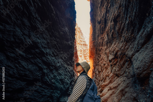 Chinese woman enjoying the beautiful scenic canyon landscape in Kuche Grand Canyon National Geopark at Kuche, Xinjiang, China photo