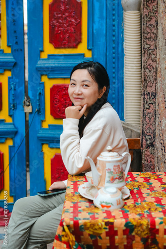 Chinese women enjoying herself in the traditional ethnic style streets of Kuche, Xinjiang, China photo