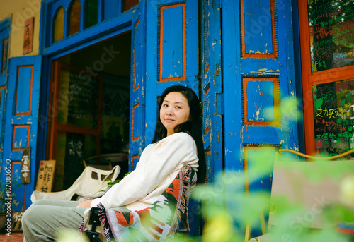 Chinese women enjoying herself in the traditional ethnic style streets of Kuche, Xinjiang, China photo